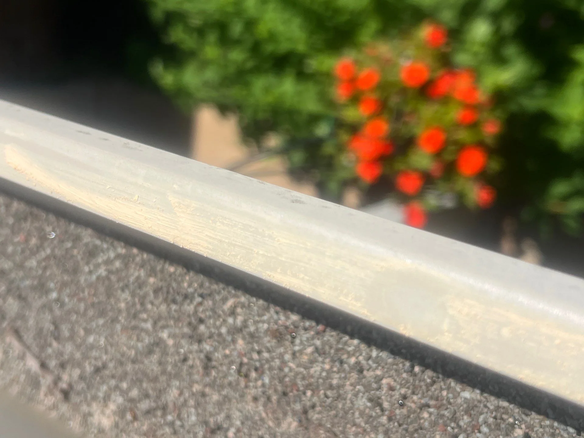 Roof fascia board and trim detail with asphalt shingles and metal flashing